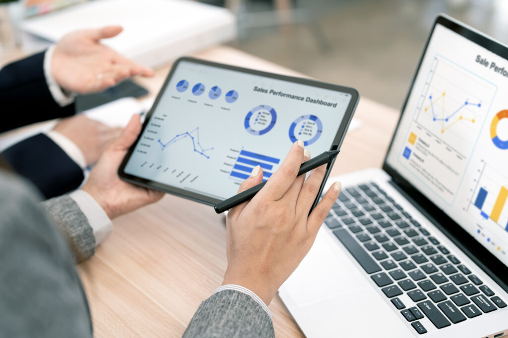 Business owner reviewing multi-location performance and sales reports on a digital dashboard