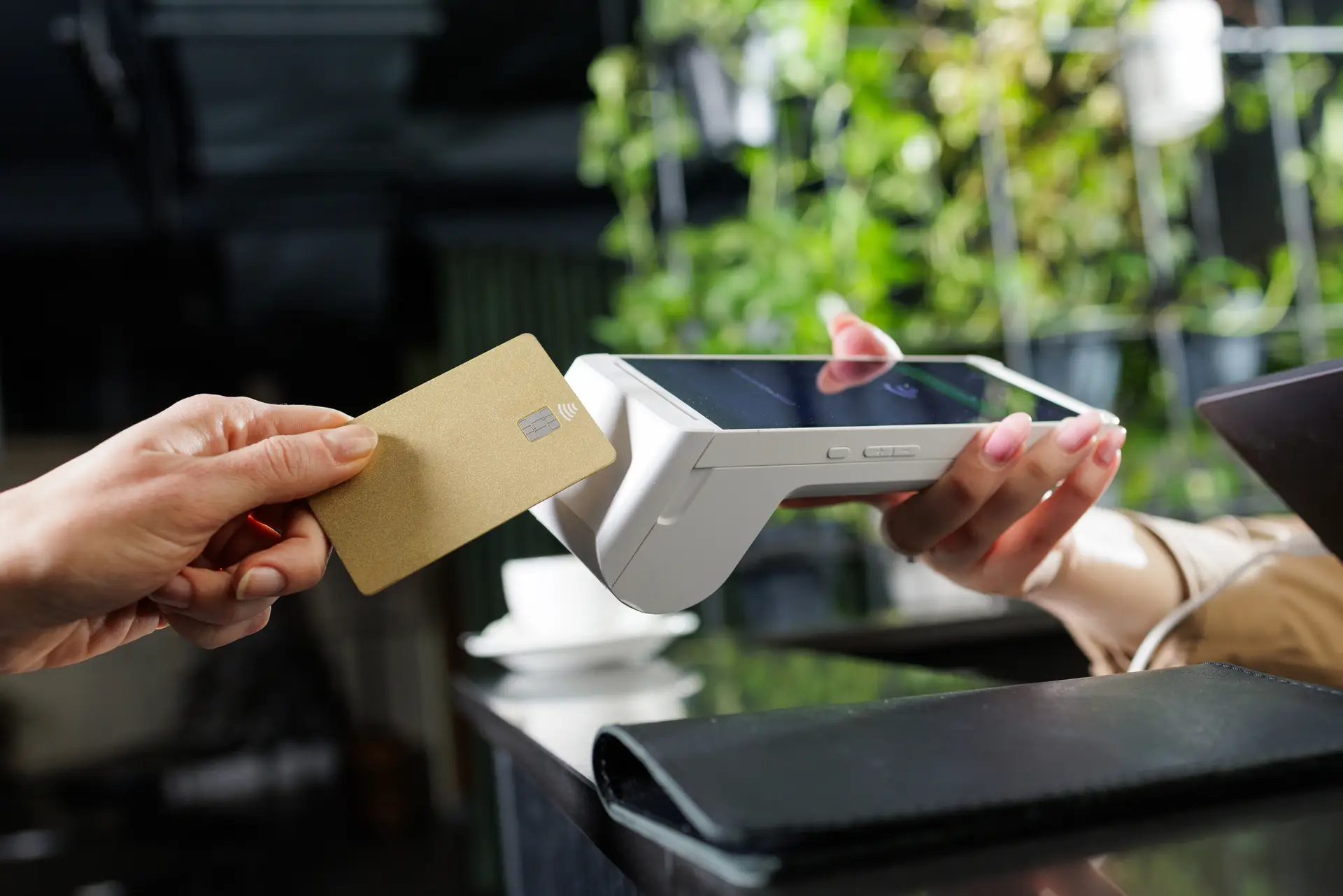 Customer making a contactless card payment at a point of sale terminal
